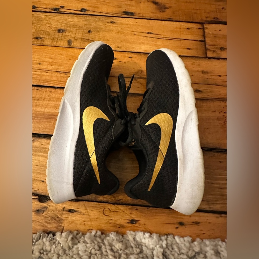 Womens 8.5 Black and gold Nike sneakers